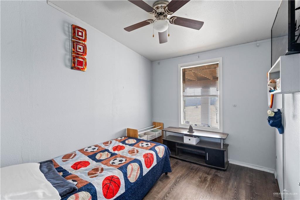 48 Gladiola Street Alamo, TX 78516 - Photo 5 of 14 a bedroom with a bed and a chandelier