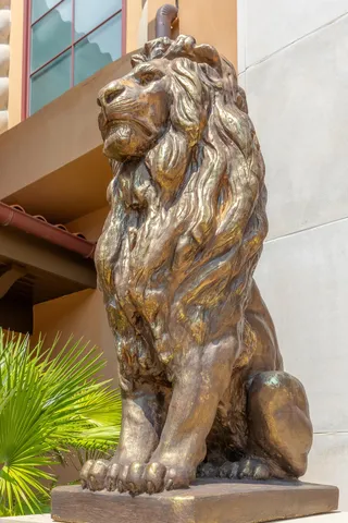 a en suite bathroom with a granite countertop sink a toilet a shower and a mirror