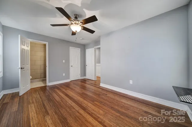 a view of an empty room and wooden floor