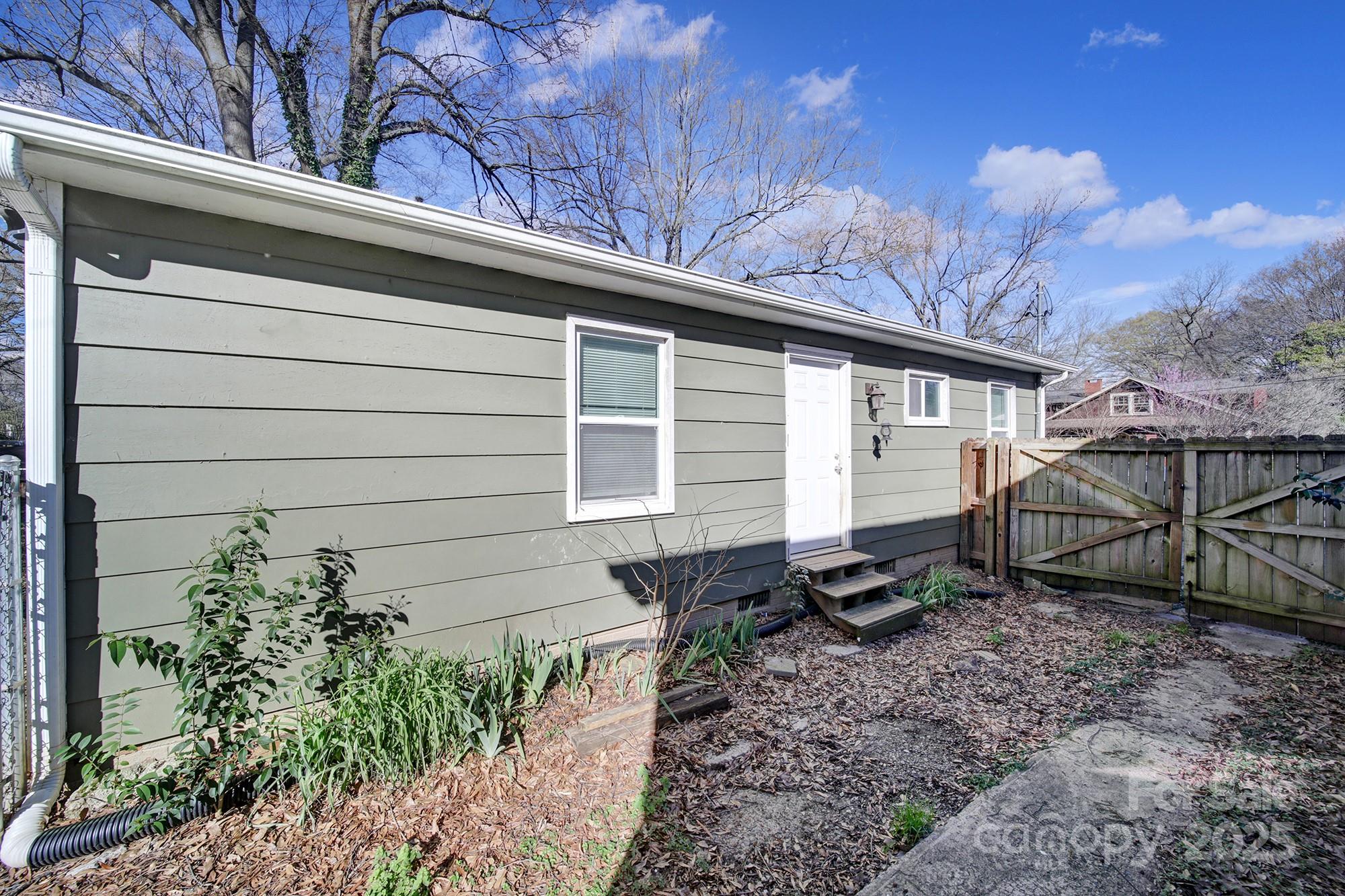 113 West 5th Avenue Gastonia, NC 28052 - Photo 16 of 18 a small barn with a white roof and table and chairs