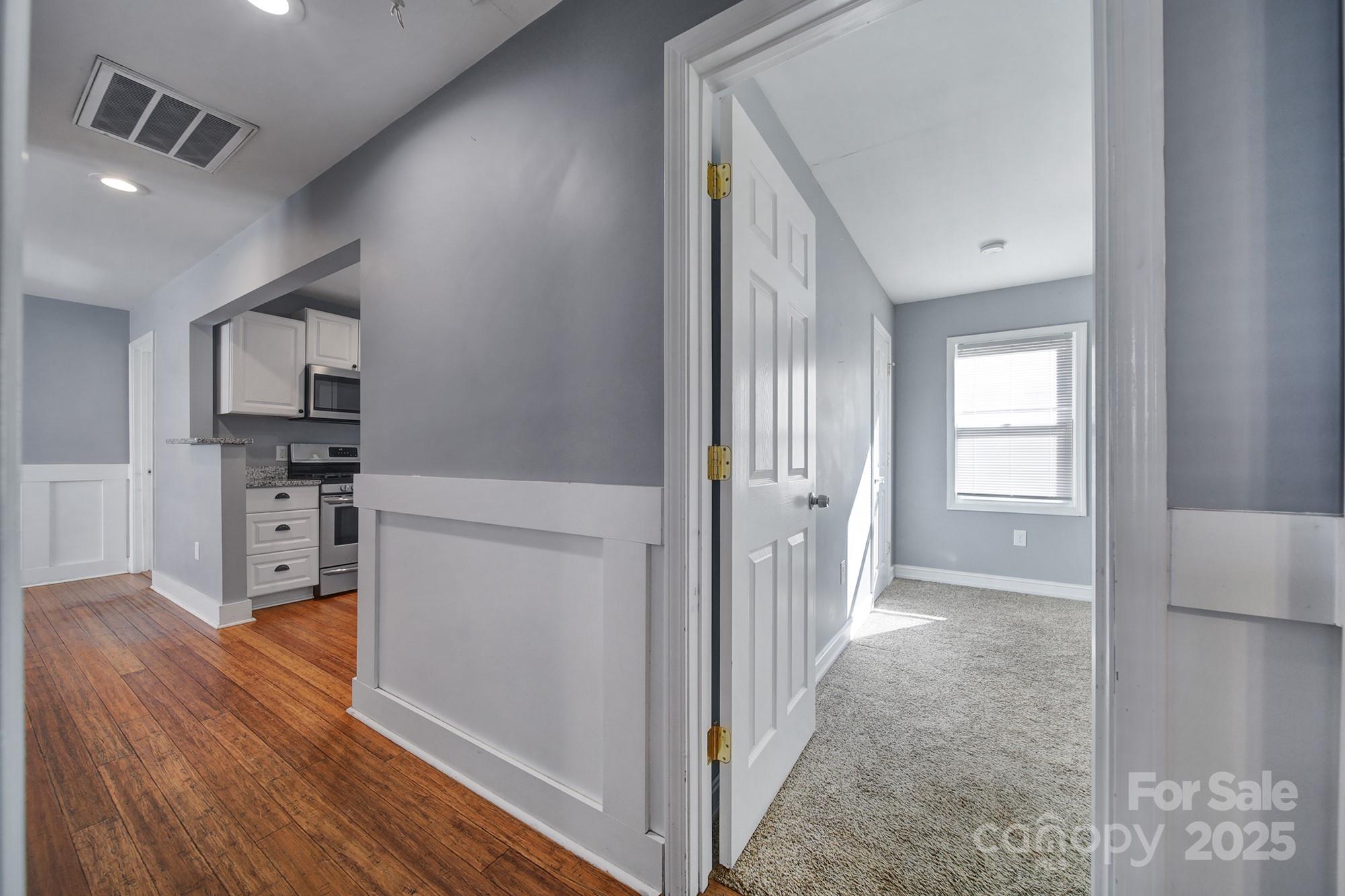 113 West 5th Avenue Gastonia, NC 28052 - Photo 4 of 18 a view of a kitchen cabinets and wooden floor