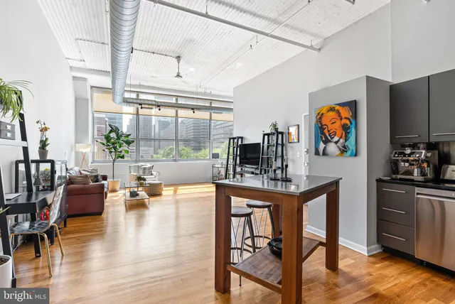 a view of kitchen with furniture and wooden floor