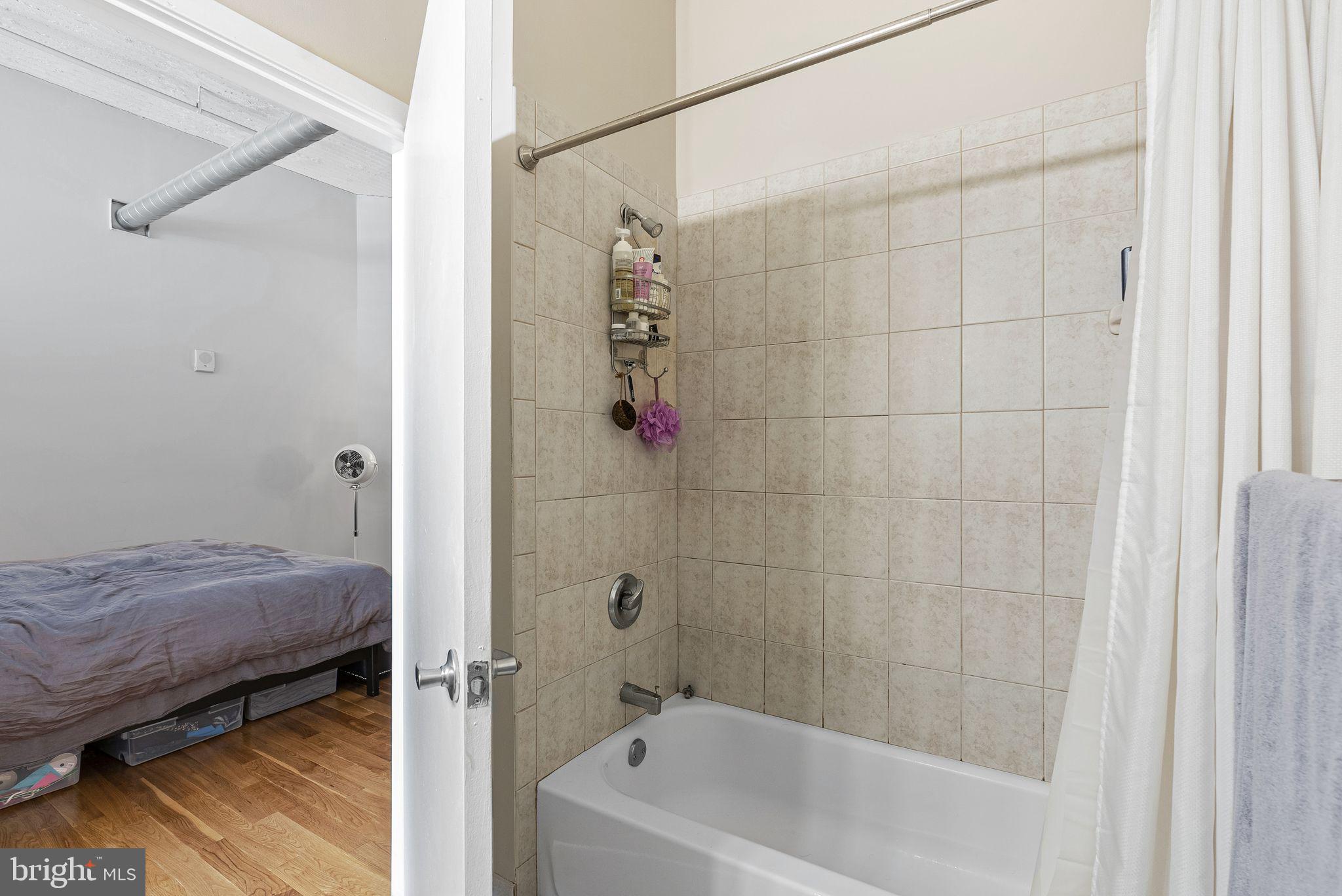 2200-28 Arch Street, Unit 409 Philadelphia, PA 19103 - Photo 12 of 25 a bathroom with a bathtub and a shower