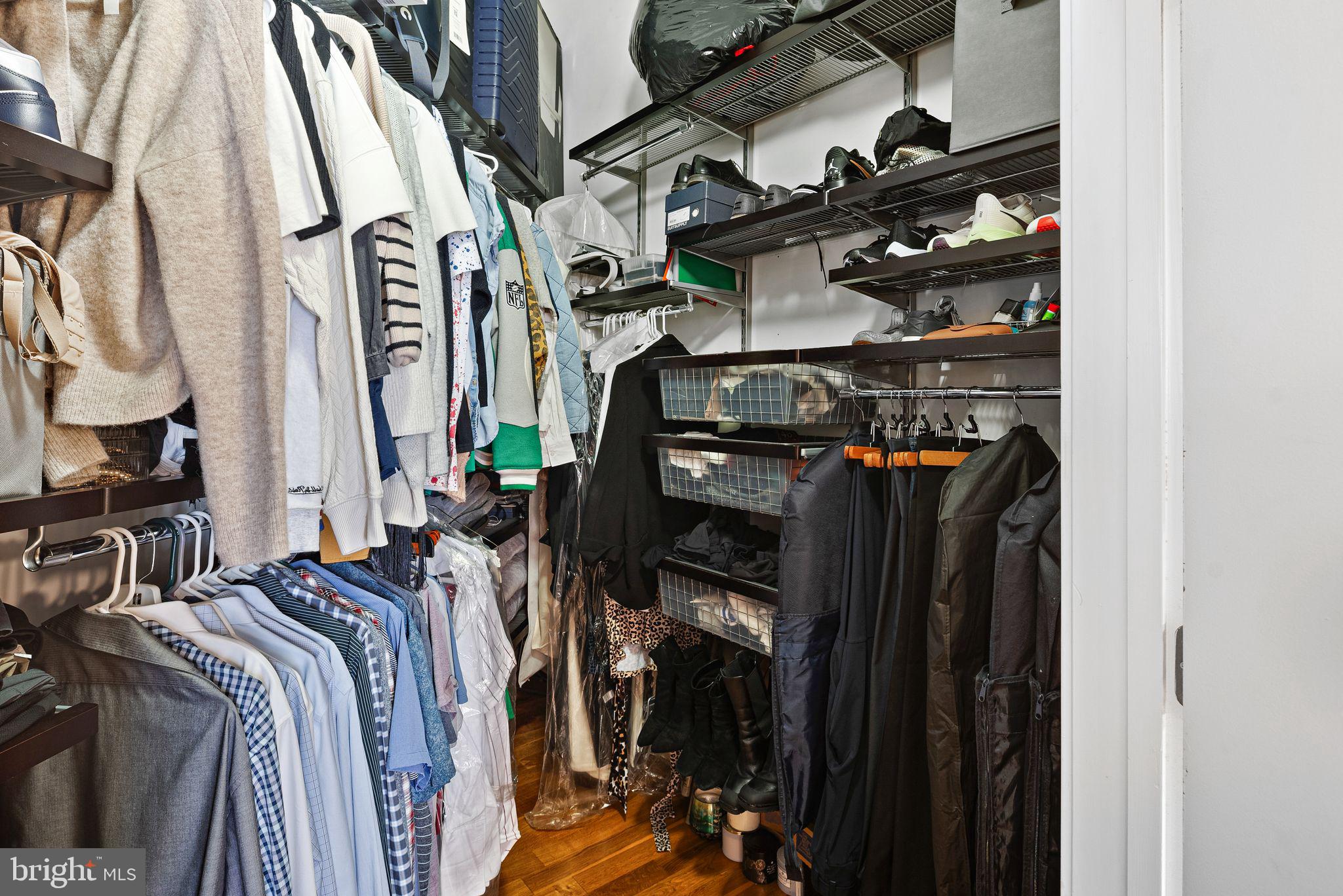 2200-28 Arch Street, Unit 409 Philadelphia, PA 19103 - Photo 14 of 25 a view of walk in closet with clothes and shoes