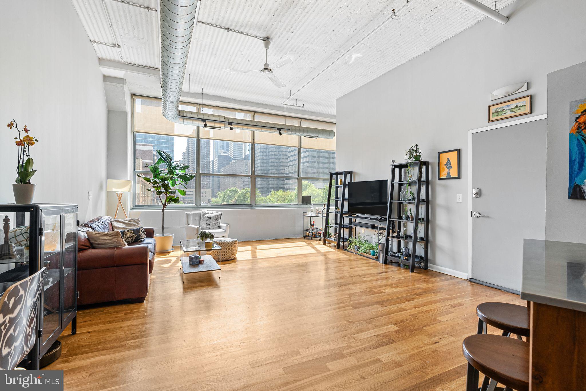 2200-28 Arch Street, Unit 409 Philadelphia, PA 19103 - Photo 2 of 25 a living room with fireplace furniture and a flat screen tv