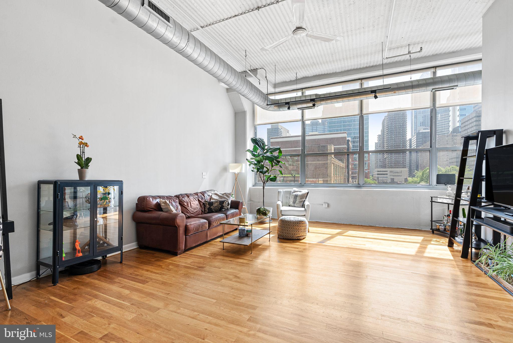 2200-28 Arch Street, Unit 409 Philadelphia, PA 19103 - Photo 4 of 25 a living room with fireplace furniture and a flat screen tv