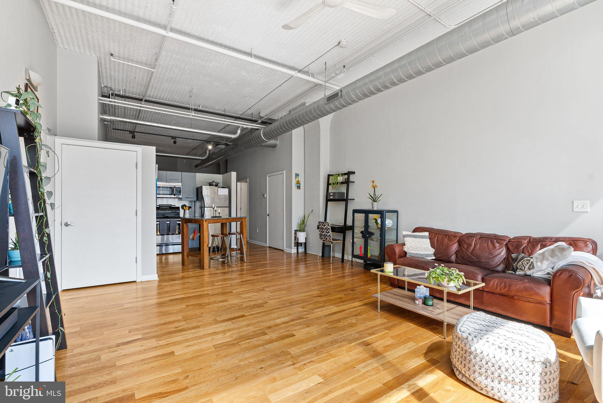 2200-28 Arch Street, Unit 409 Philadelphia, PA 19103 - Photo 5 of 25 a living room with furniture and a wooden floor