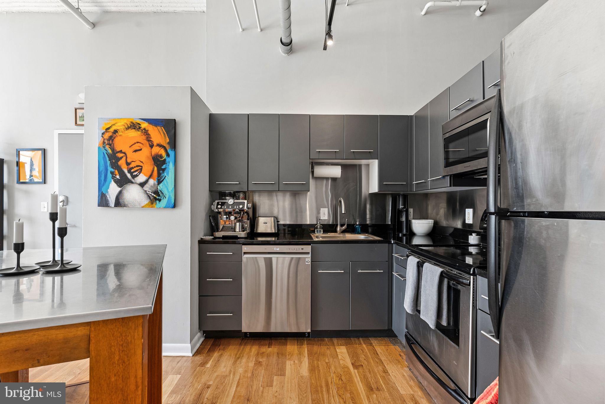 2200-28 Arch Street, Unit 409 Philadelphia, PA 19103 - Photo 7 of 25 a kitchen with stainless steel appliances granite countertop a refrigerator and a sink