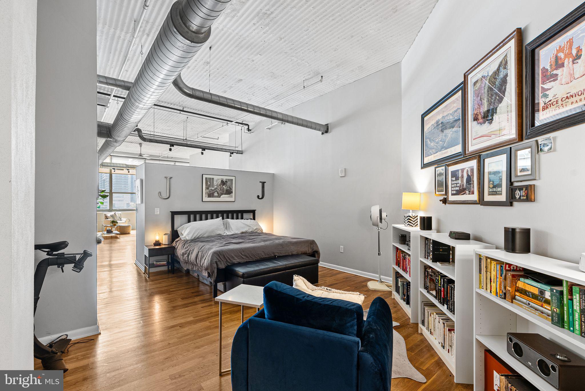 2200-28 Arch Street, Unit 409 Philadelphia, PA 19103 - Photo 8 of 25 a bedroom with furniture and a book shelf