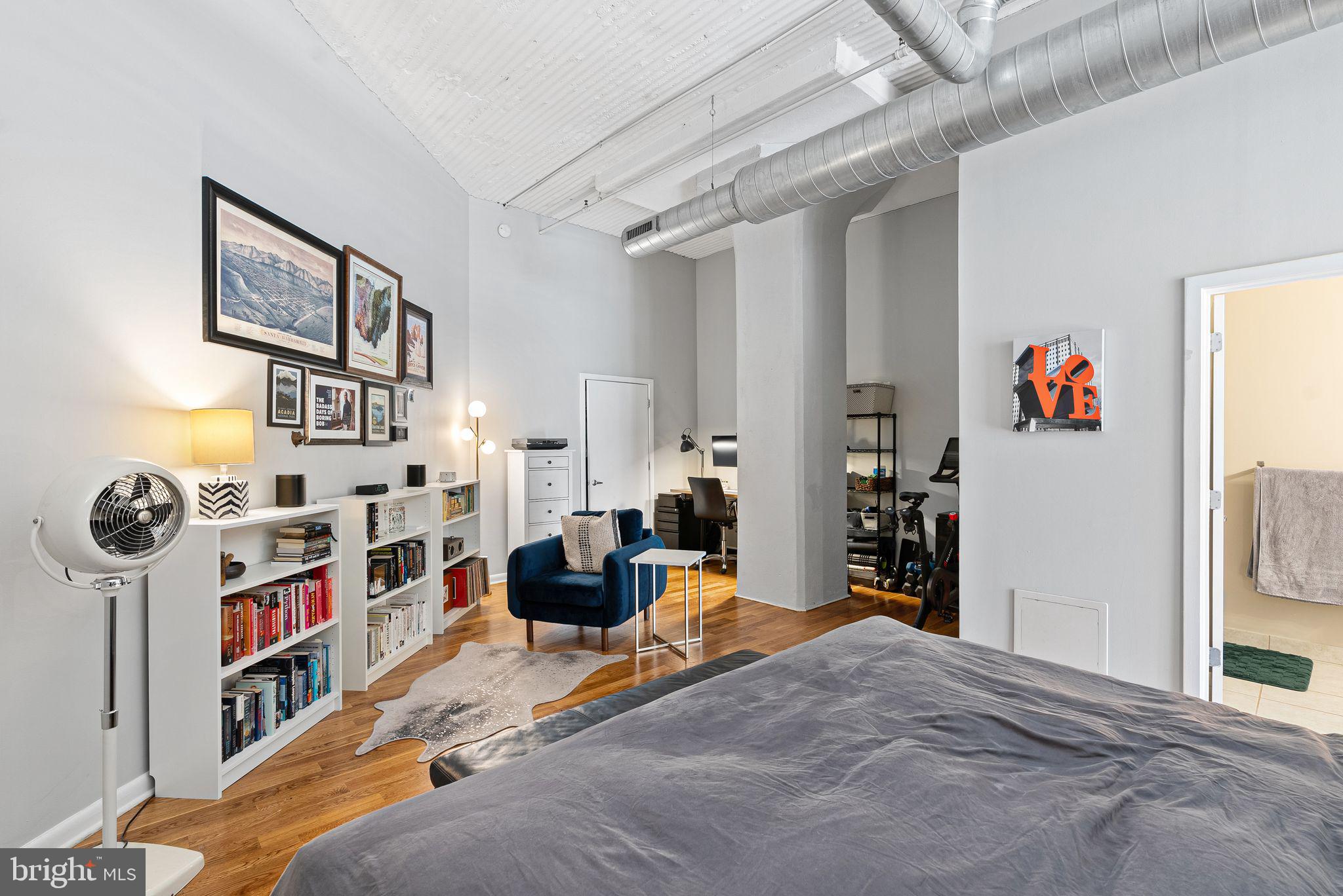 2200-28 Arch Street, Unit 409 Philadelphia, PA 19103 - Photo 9 of 25 a bedroom with furniture and a book shelf