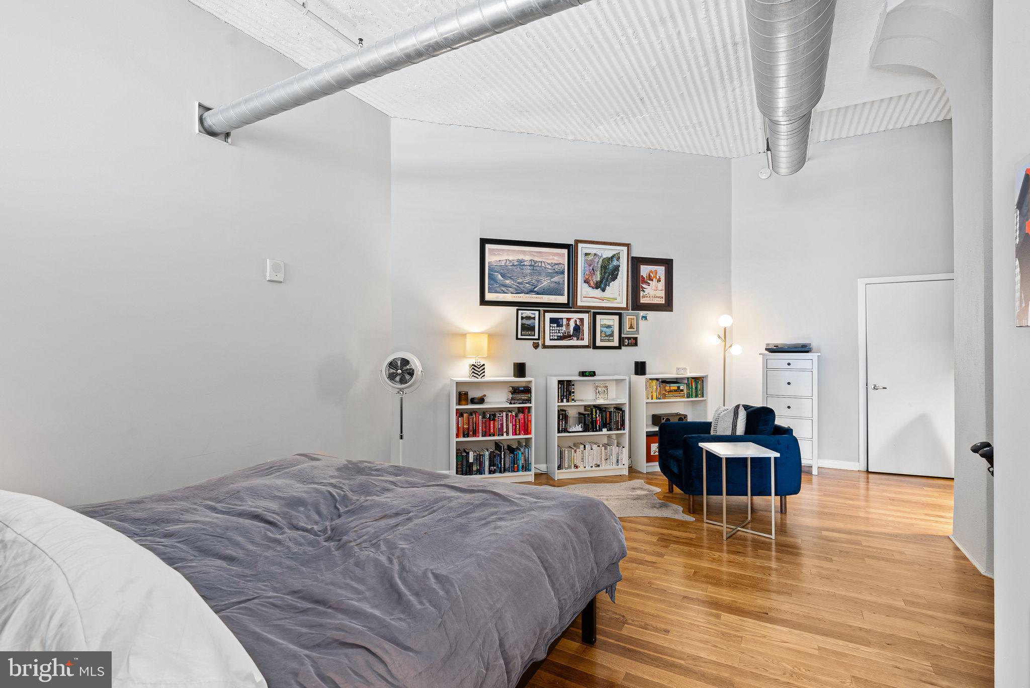 2200-28 Arch Street, Unit 409 Philadelphia, PA 19103 - Photo 10 of 25 a bedroom with furniture and a wooden floor