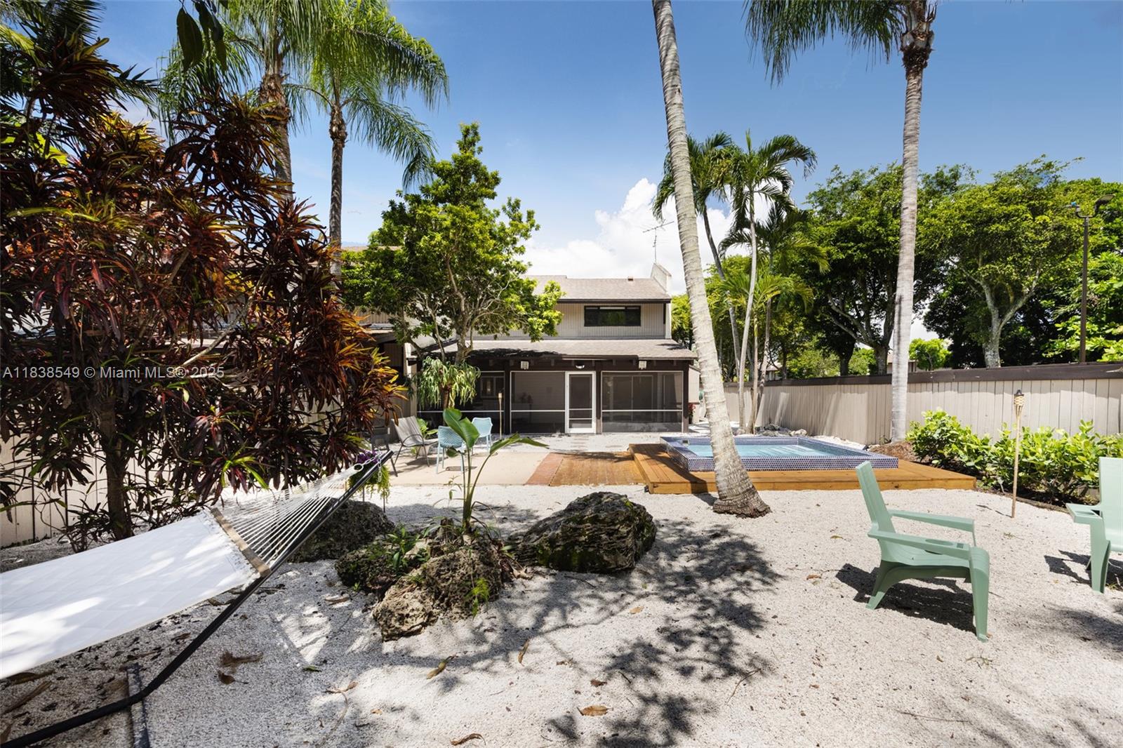 a view of a swimming pool with a patio and plants