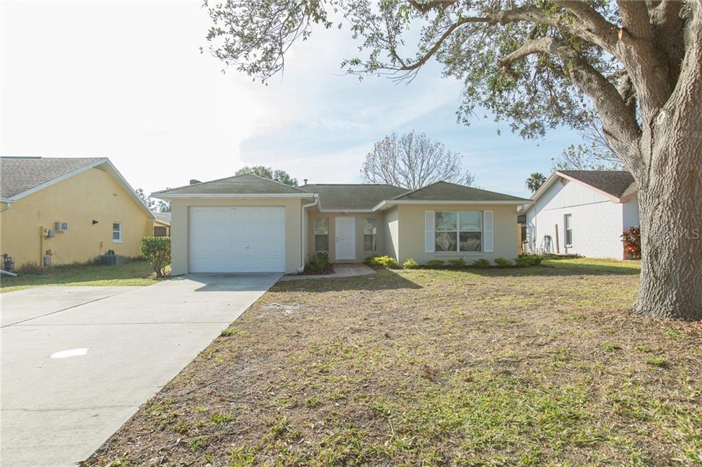 5416 Struthers Road Winter Haven, FL 33884 - Photo 1 of 1 a front view of a house with a garden