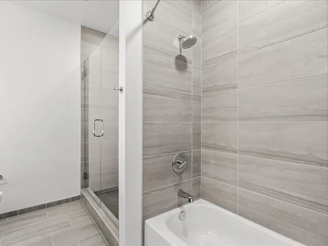 a bathroom with a bathtub and a shower