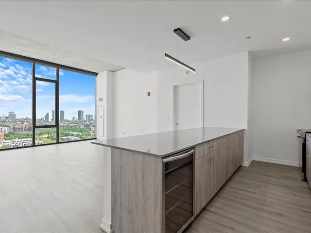 a view of a kitchen with a sink and wooden floor