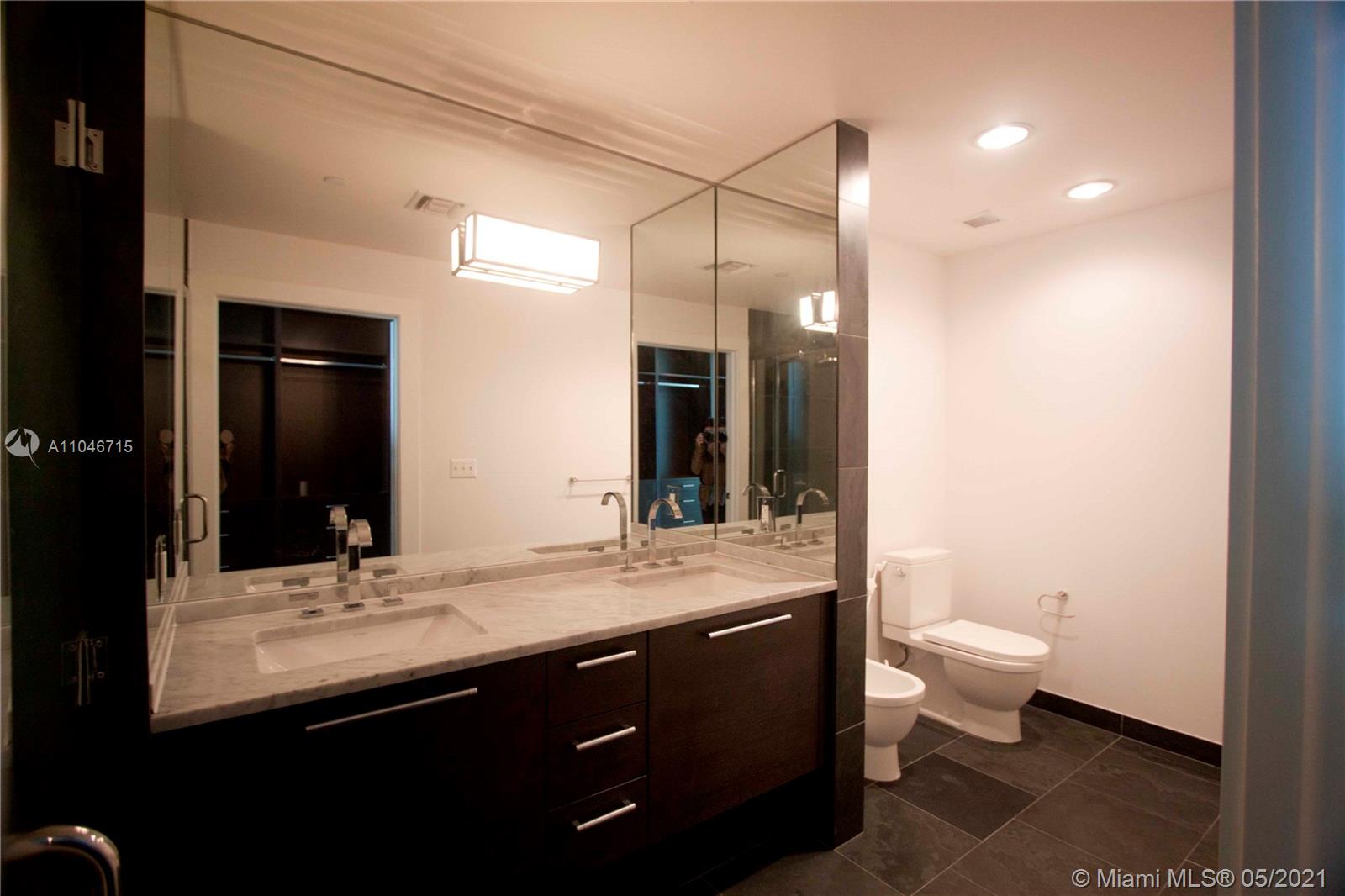 900 Biscayne Boulevard, Unit 5502 Miami, FL 33132 - Photo 11 of 19 a bathroom with a sink and a mirror