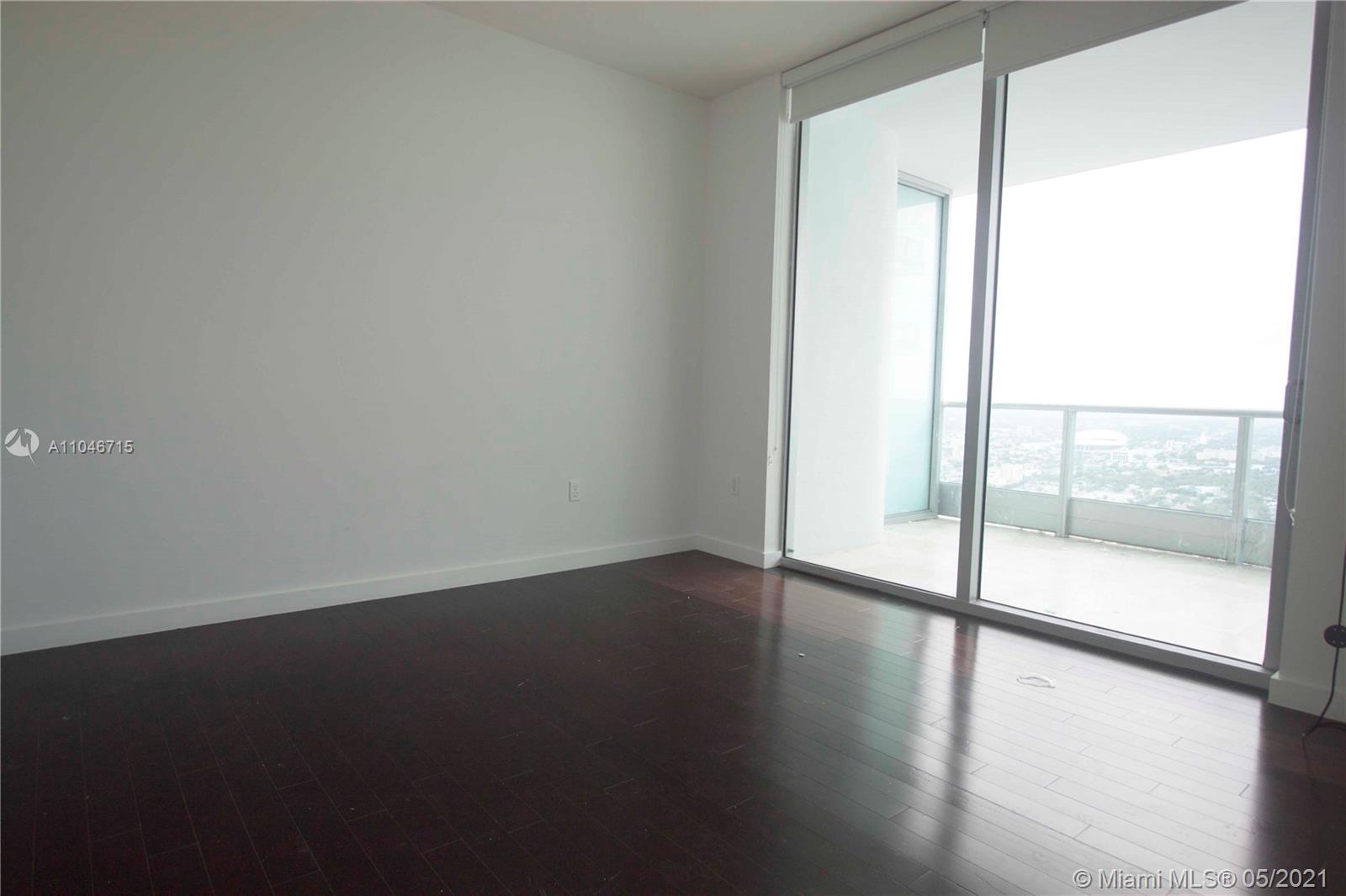 900 Biscayne Boulevard, Unit 5502 Miami, FL 33132 - Photo 13 of 19 a view of an empty room with wooden floor
