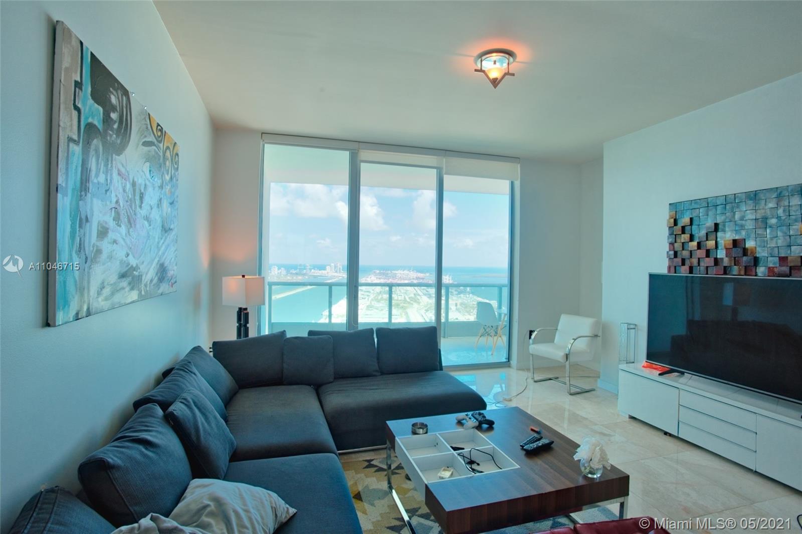 900 Biscayne Boulevard, Unit 5502 Miami, FL 33132 - Photo 4 of 19 a living room with furniture and a flat screen tv