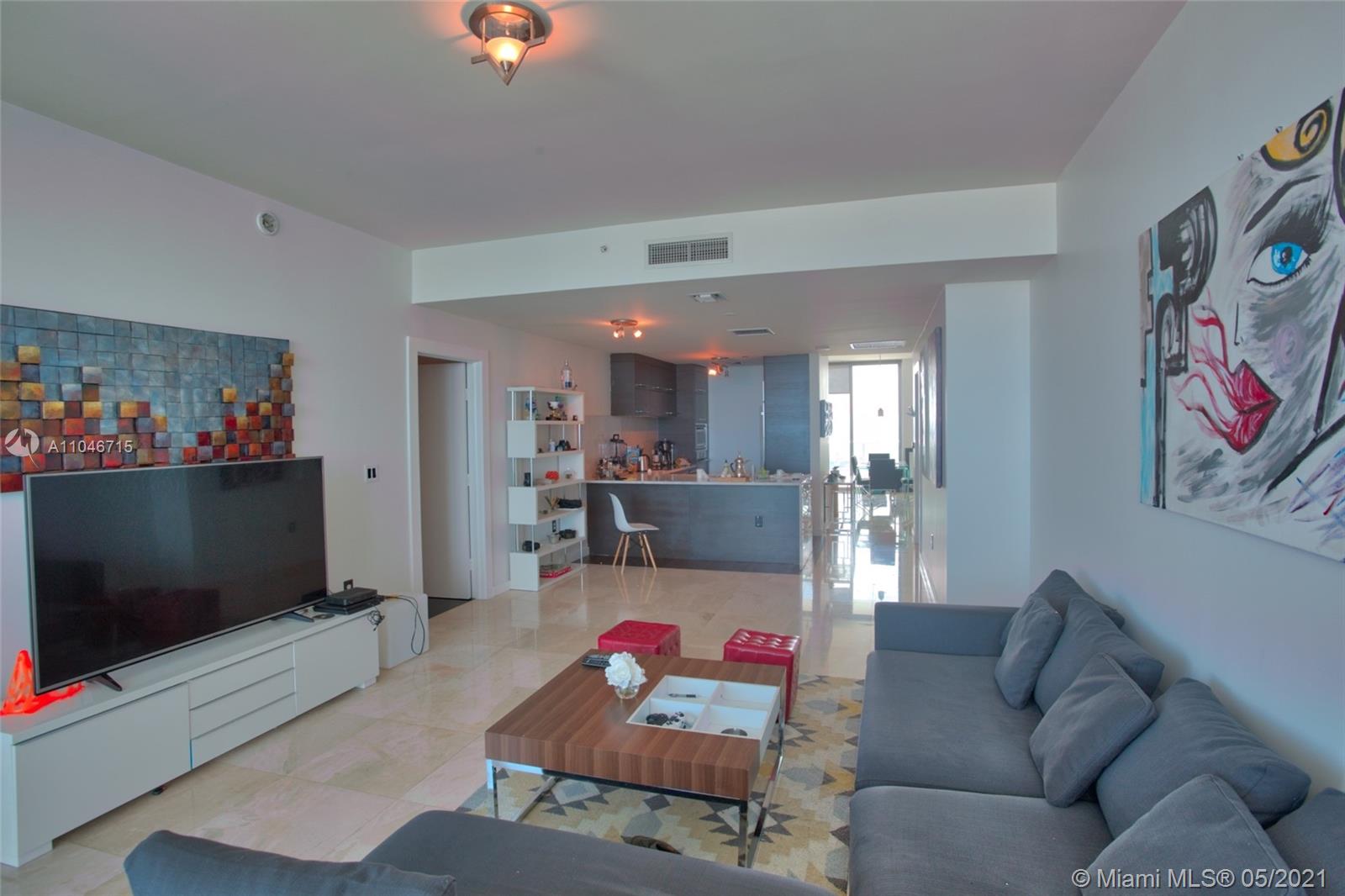 900 Biscayne Boulevard, Unit 5502 Miami, FL 33132 - Photo 5 of 19 a living room with furniture and a flat screen tv