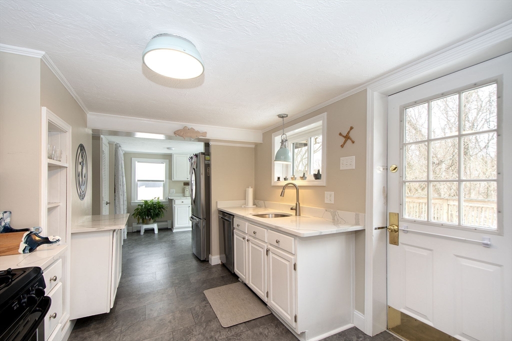 85 Constitution Road Marshfield, MA 02050 - Photo 13 of 36 a large white kitchen with a large window