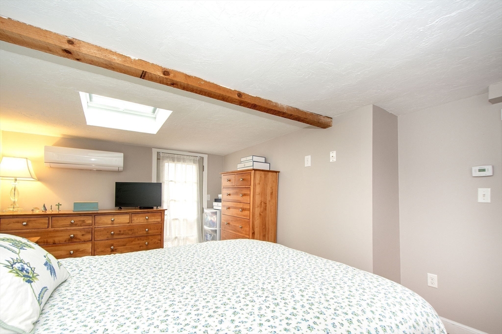 85 Constitution Road Marshfield, MA 02050 - Photo 22 of 36 a bedroom with a bed and a flat screen tv