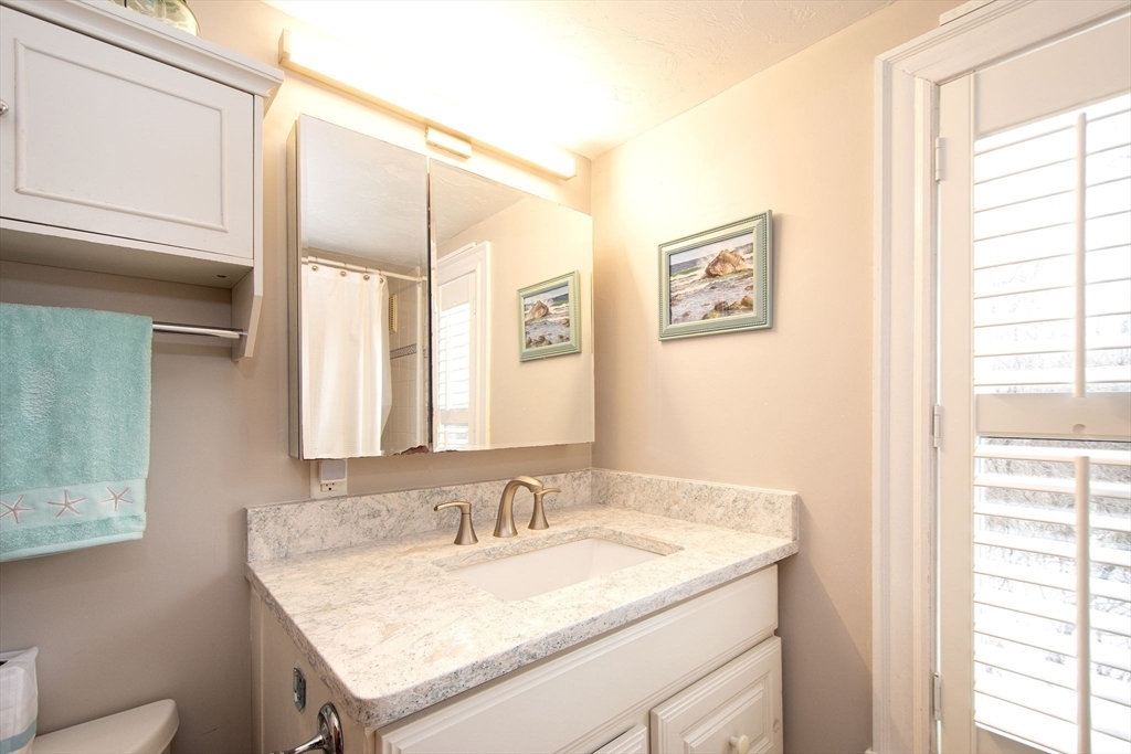 85 Constitution Road Marshfield, MA 02050 - Photo 23 of 36 a bathroom with a granite countertop sink and a mirror
