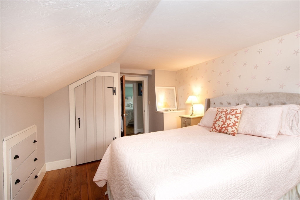 85 Constitution Road Marshfield, MA 02050 - Photo 27 of 36 a bedroom with a bed and wooden floor