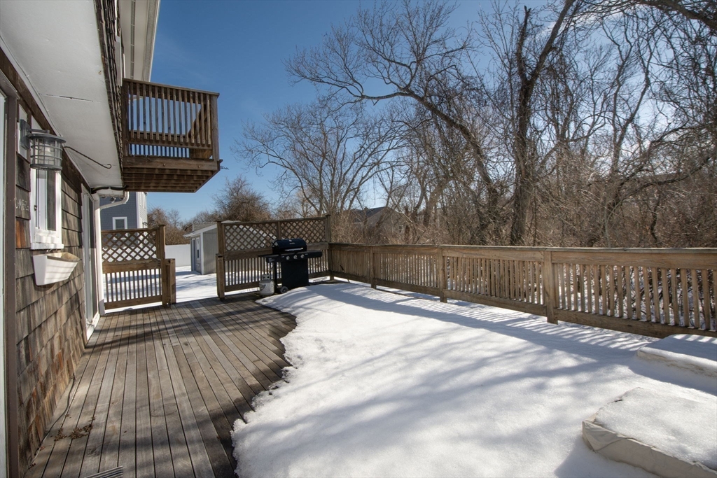 85 Constitution Road Marshfield, MA 02050 - Photo 31 of 36 a view of a backyard with wooden fence and a bench