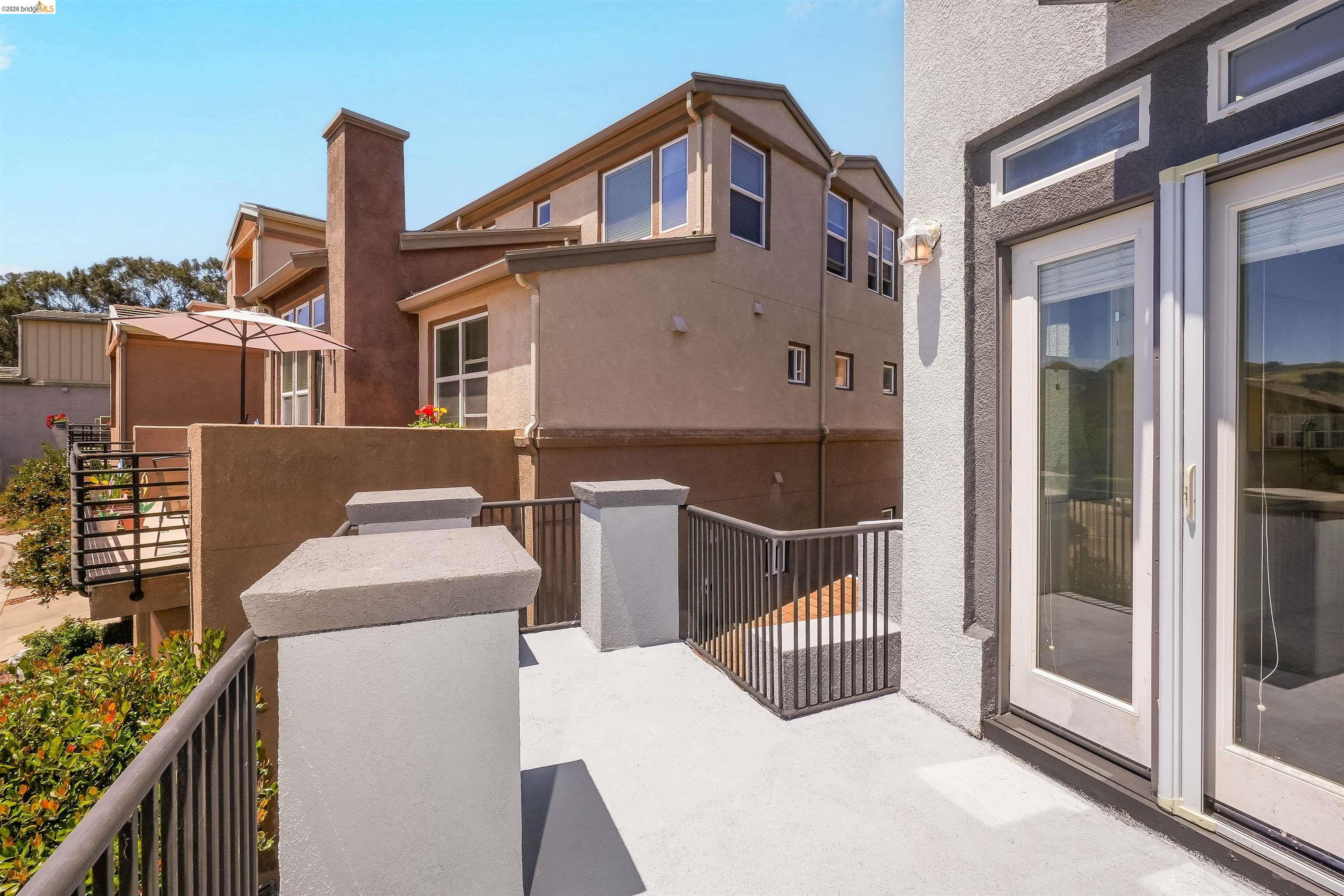 449 Constantine Court San Ramon, CA 94583 - Photo 31 of 63 Spacious exterior balcony featuring durable light-colored surfacing, dark metal railings, and dual glass-paned doors