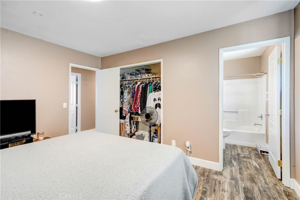 15395 Apache Road Apple Valley, CA 92307 - Photo 12 of 20 a bed room with a bed and a television