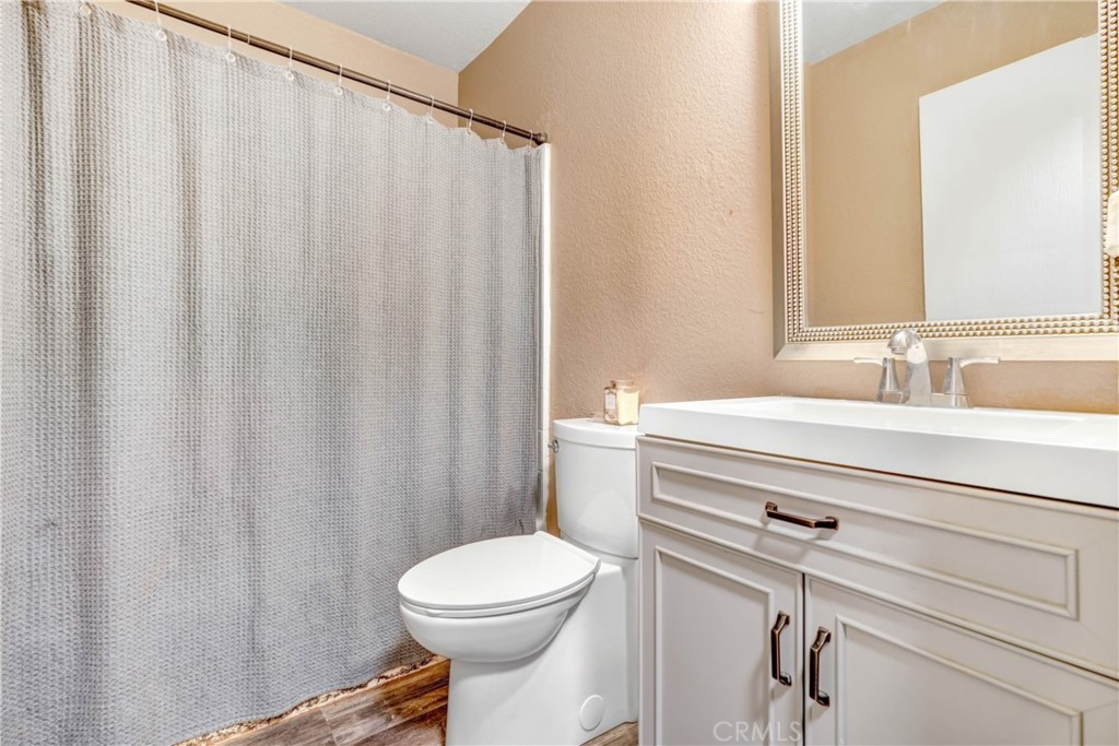 15395 Apache Road Apple Valley, CA 92307 - Photo 18 of 20 a bathroom with a sink a toilet and shower