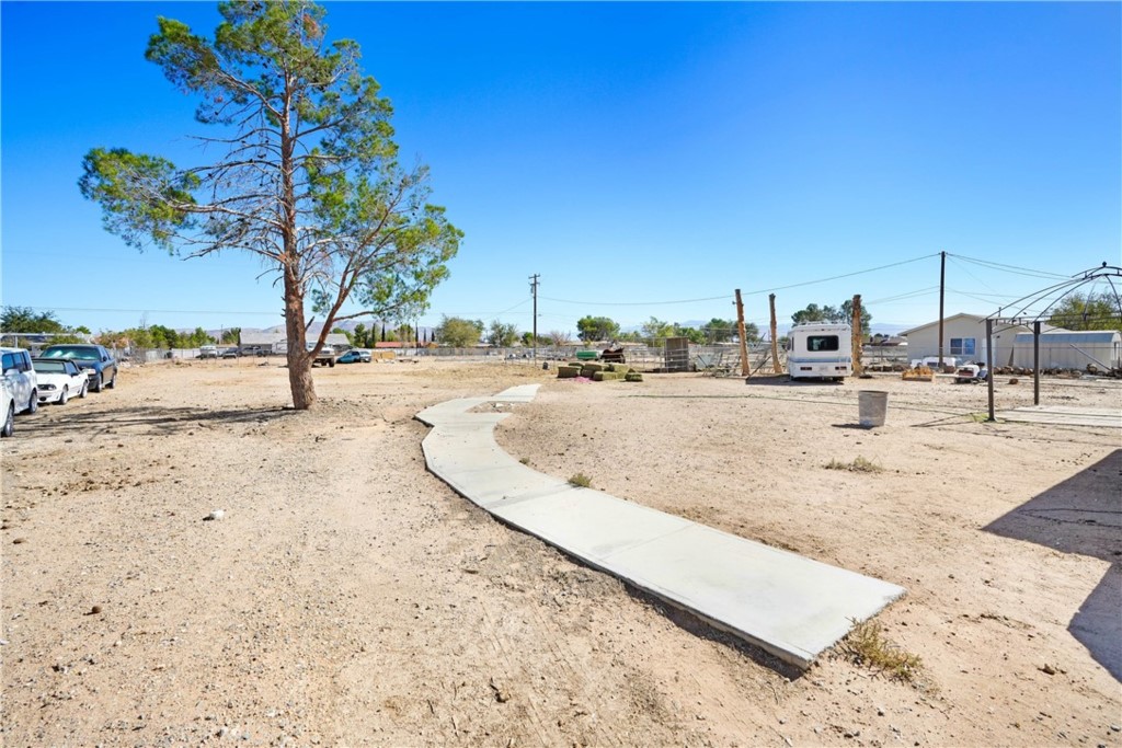 15395 Apache Road Apple Valley, CA 92307 - Photo 19 of 20 a view of a yard with a tree
