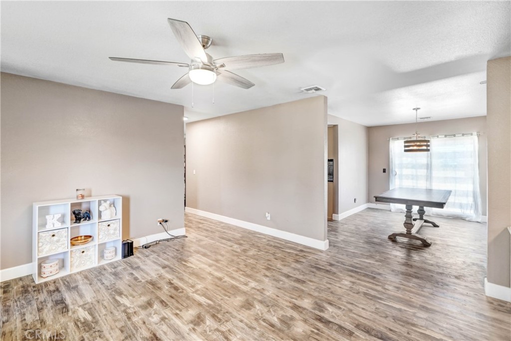 15395 Apache Road Apple Valley, CA 92307 - Photo 5 of 20 a view of a bedroom with a bed and wooden floor