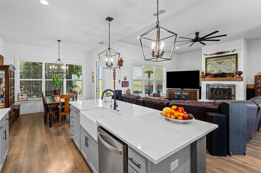 2045 Ellis Ridge Drive Weatherford, TX 76087 - Photo 12 of 40 Kitchen with gray cabinets, recessed lighting, light stone counters, hanging light fixtures, and dishwasher
