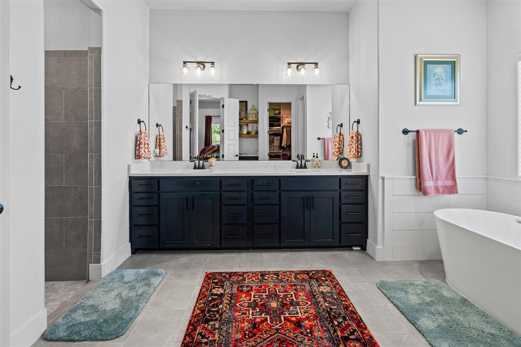 2045 Ellis Ridge Drive Weatherford, TX 76087 - Photo 17 of 40 Bathroom with double vanity, a freestanding tub, light tile patterned floors, and walk in shower