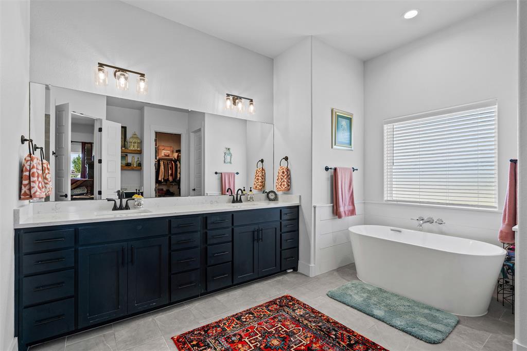 2045 Ellis Ridge Drive Weatherford, TX 76087 - Photo 19 of 40 Ensuite bathroom featuring a soaking tub, double vanity, recessed lighting, light tile patterned floors, and a walk in closet