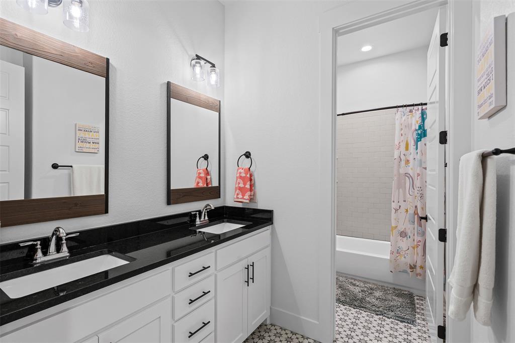 2045 Ellis Ridge Drive Weatherford, TX 76087 - Photo 22 of 40 Full bath with shower / bath combo with shower curtain, double vanity, and light tile patterned flooring