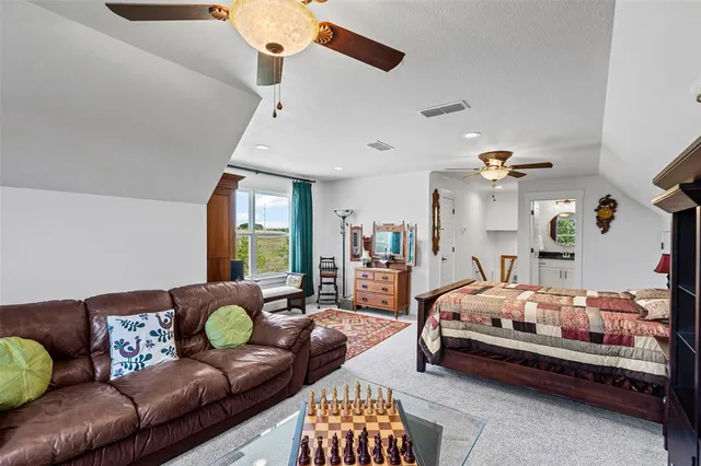 a bedroom with furniture and a large window