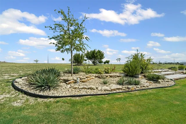 a view of a house with a yard patio and fire pit