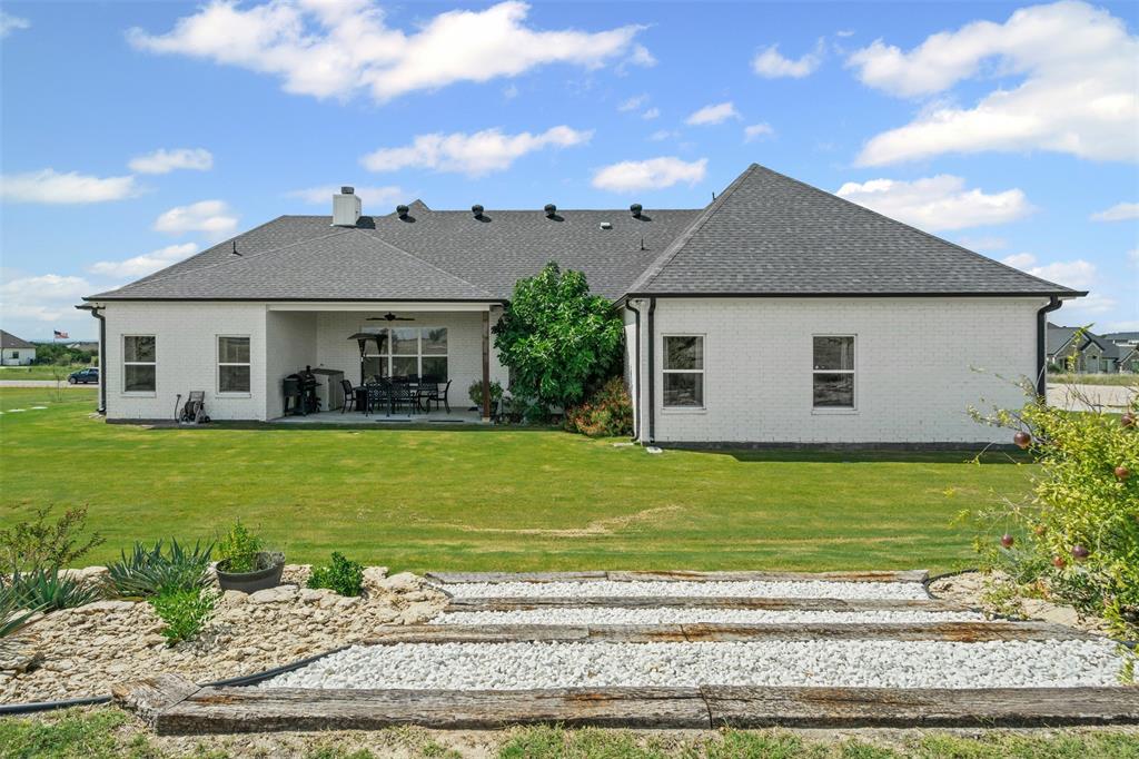2045 Ellis Ridge Drive Weatherford, TX 76087 - Photo 33 of 40 Rear view of property with a ceiling fan, a lawn, a patio area, and brick siding