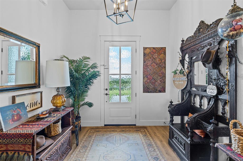 2045 Ellis Ridge Drive Weatherford, TX 76087 - Photo 4 of 40 entry with wood finished floors and a chandelier