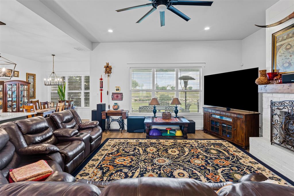 2045 Ellis Ridge Drive Weatherford, TX 76087 - Photo 5 of 40 Living room with, a fireplace, recessed lighting, a ceiling fan, and a chandelier