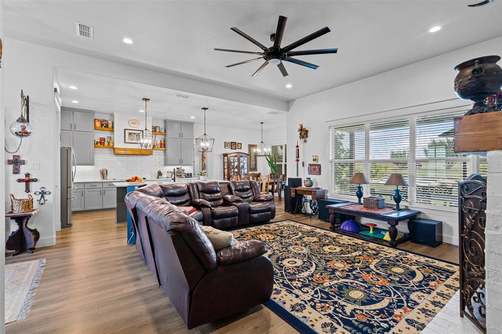 2045 Ellis Ridge Drive Weatherford, TX 76087 - Photo 6 of 40 Living area featuring recessed lighting, a chandelier, light wood-style floors, and a ceiling fan