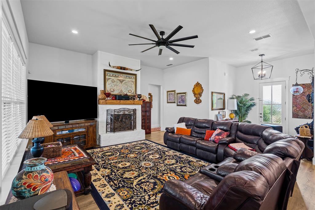 2045 Ellis Ridge Drive Weatherford, TX 76087 - Photo 7 of 40 Living room with a large fireplace, light wood-type flooring, recessed lighting, and a ceiling fan