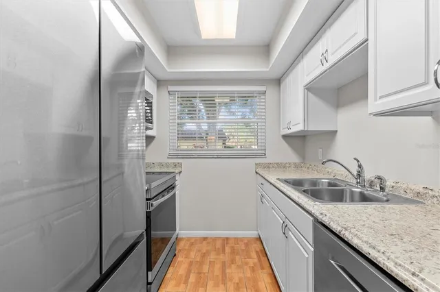 a kitchen with a sink stove and refrigerator