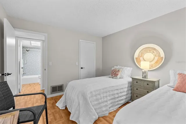 a bedroom with a bed and chair in it