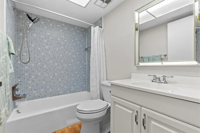 a bathroom with a sink toilet vanity and shower