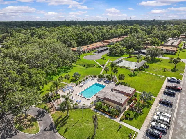 an aerial view of a house with a garden and lake view