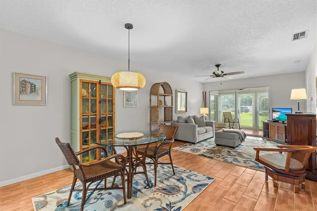 a living room with furniture a window and a chandelier