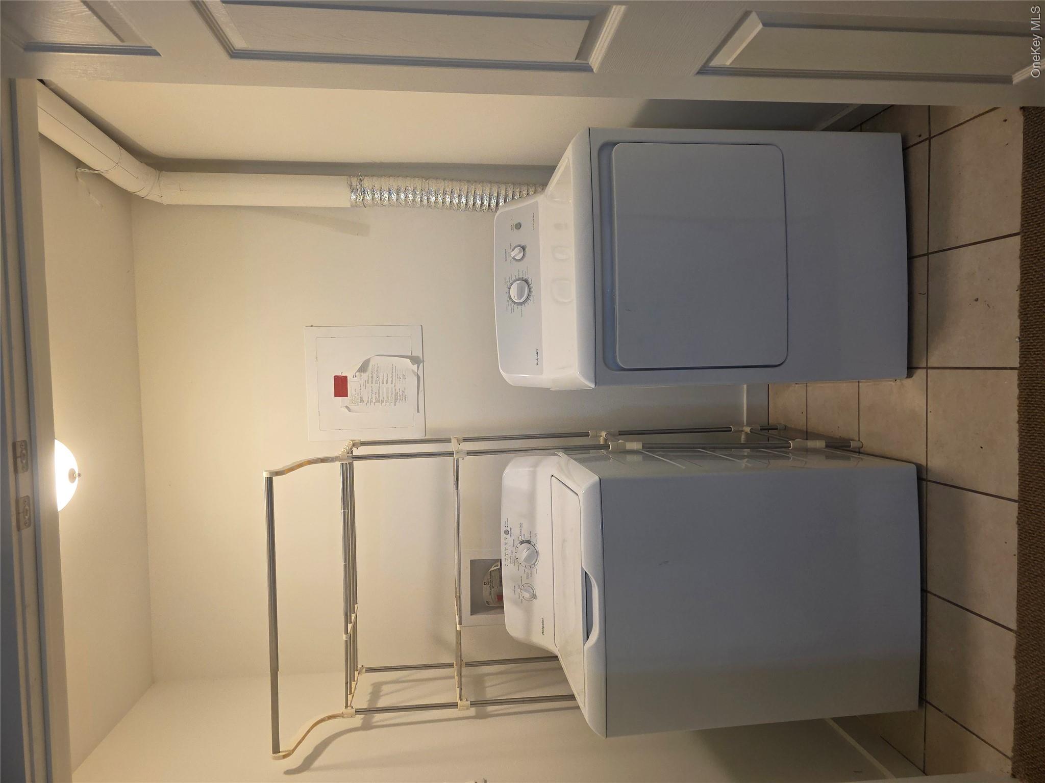 231 Reynolds Road, Unit 11 Loch Sheldrake, NY 12759 - Photo 10 of 20 Clothes washing area featuring laundry area, washing machine and clothes dryer, and light tile patterned floors